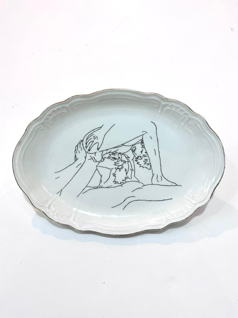 Wide elliptic format porcelain plate engraved with art by Omri Danino - Two male models during fellatio. Engraved black on white plate 