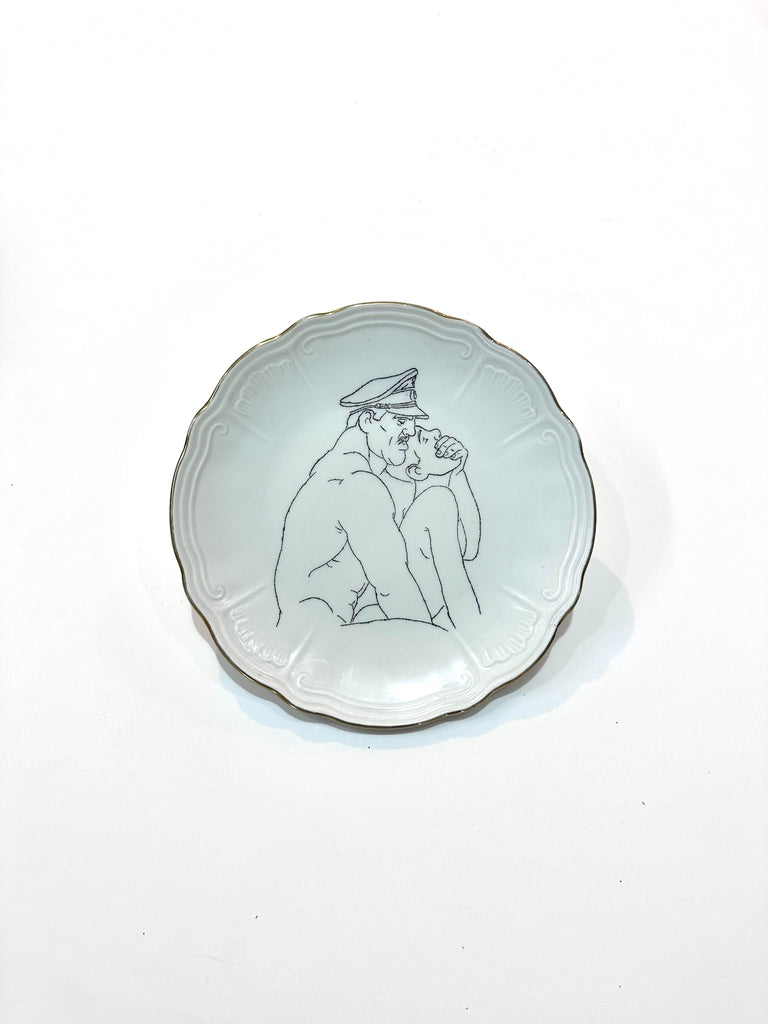 Omri Danino Porcelain Plate engraved with a drawing of older man and younger man during intercourse in black on white, older man is with uniform hat and gagging younger man from behind