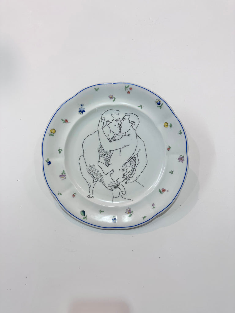 Omri Danino Porcelain Plate engraved with a drawing of older man and younger man during intercourse in black on white plate with blue rim and colorful decorations 